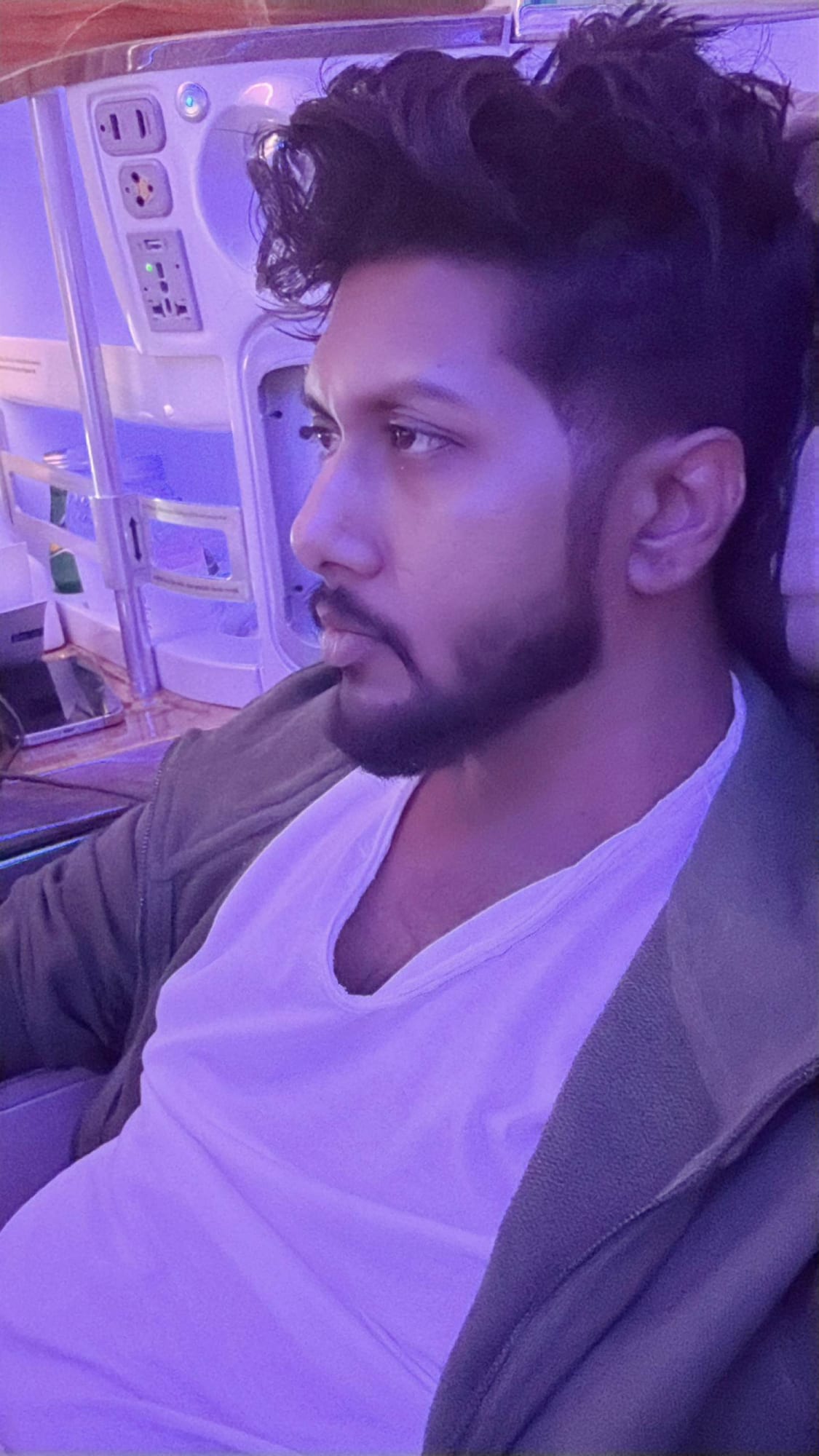 Profile portrait of Vinay Anuragh in violet cabin light